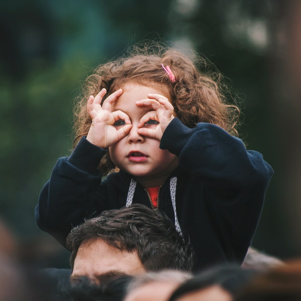 Therapy for Children_Ladybug Counseling_Image of a girl on her dad's shoulders